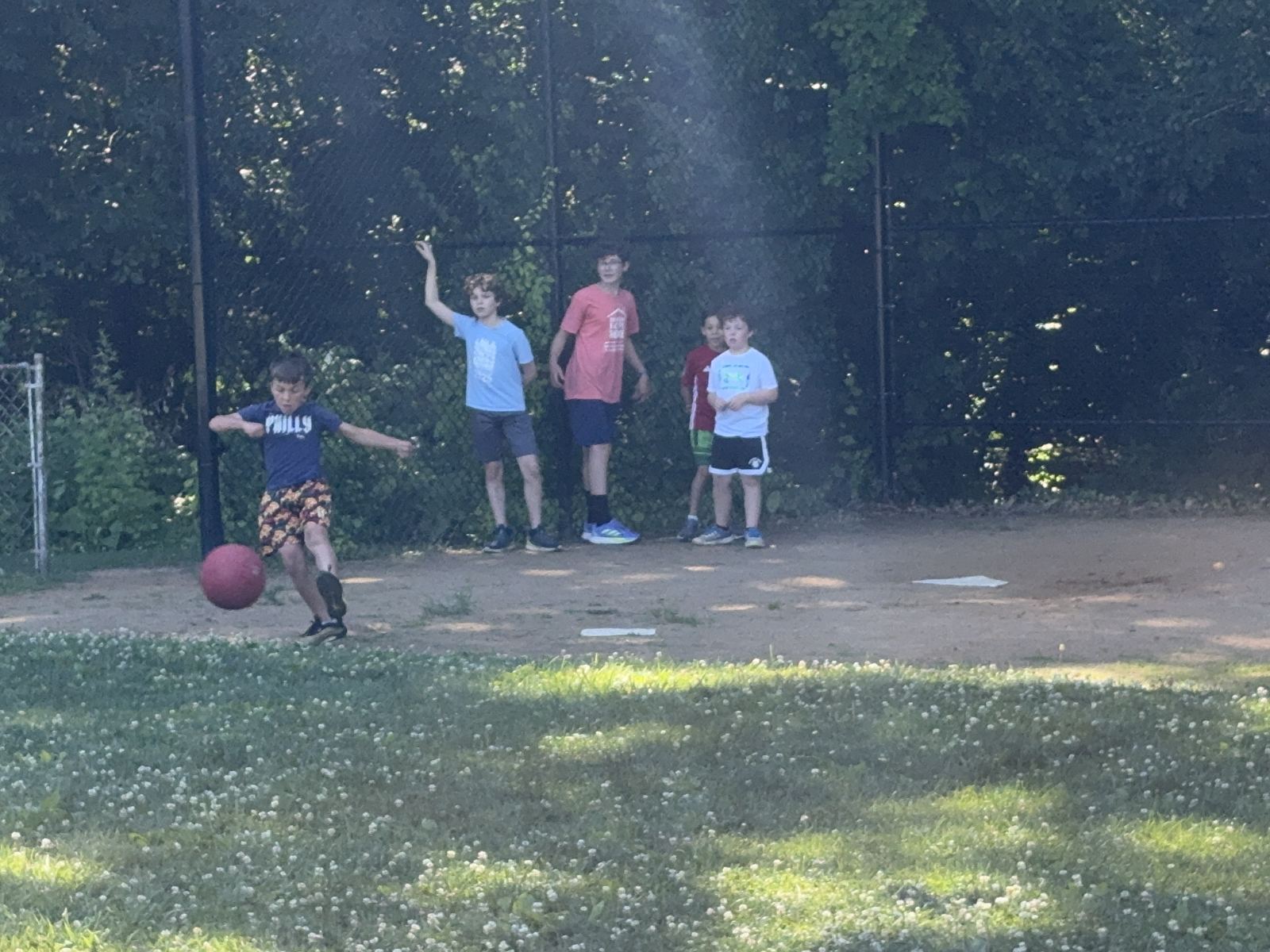Logan showing the older kids how to hit