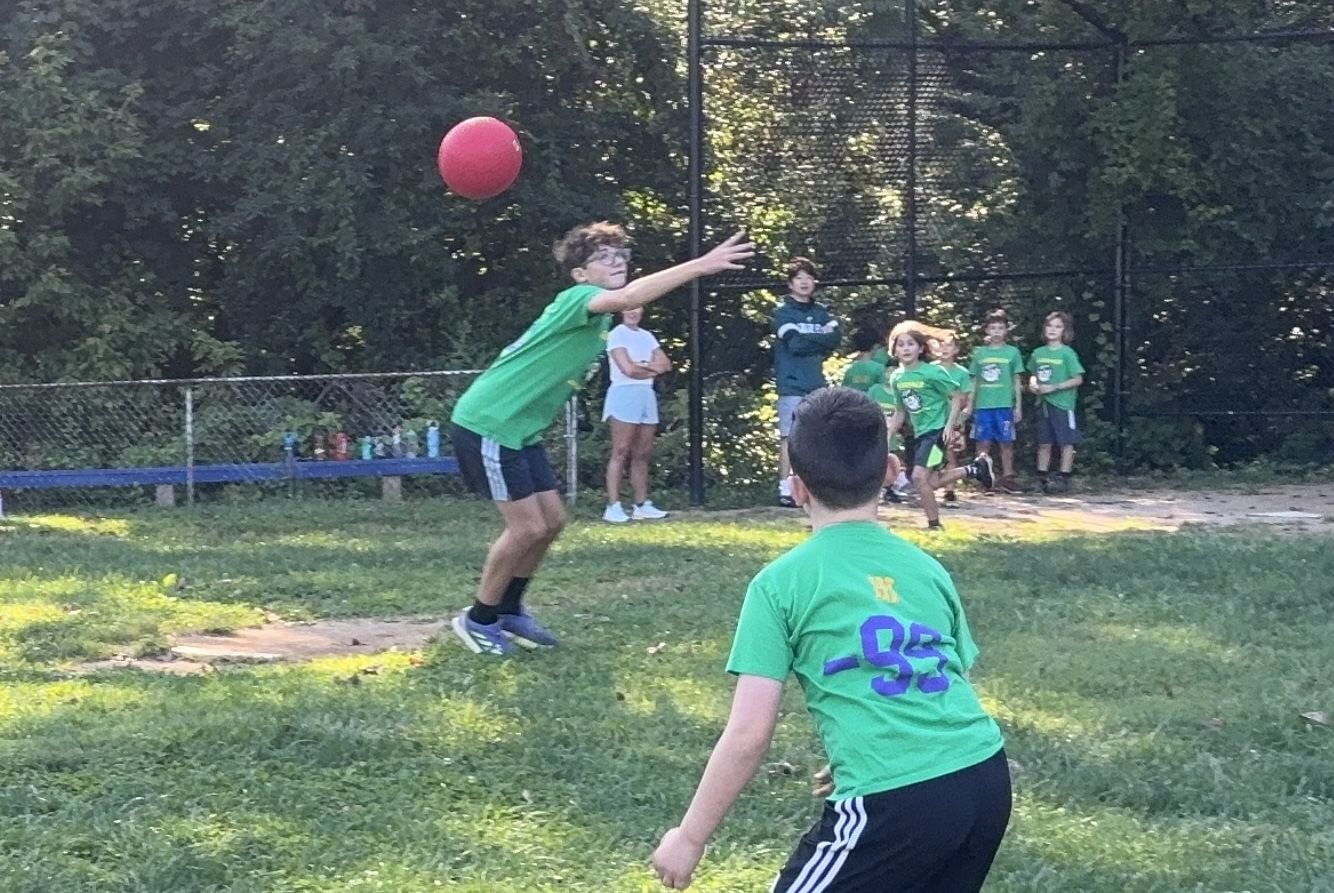 Brady sneaks the ball by his brother's gigantic arms